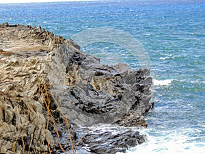 Coastline and rugged lava rocks called DragonÃ¢â¬â¢s Teeth and crashing waves at Makaluapuna Point near Kapalua, Maui, HI, USA